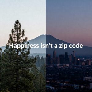 Simple graphic: 'Happiness isn’t a zip code' with mountain and city silhouette